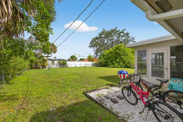 a view of a house with backyard sitting area and garden
