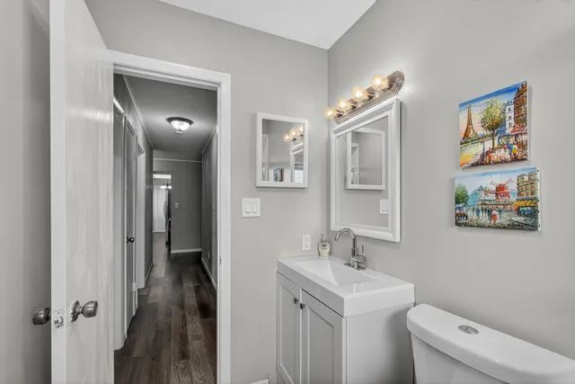 a bathroom with a sink a toilet and a mirror