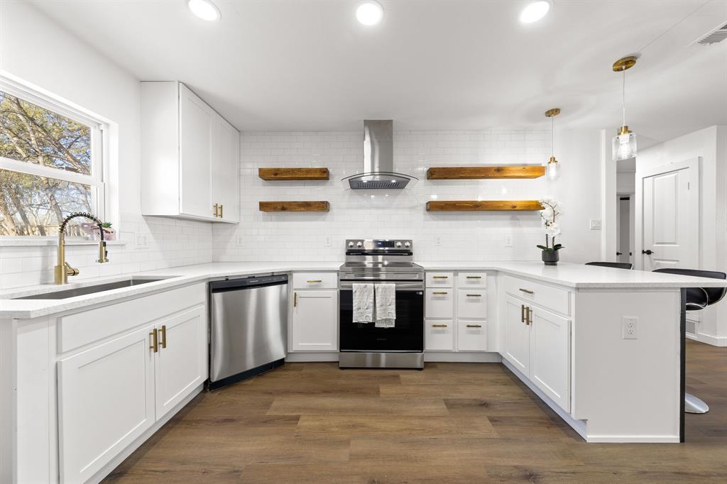 3227 Mayhew Drive Dallas, TX 75228 - Photo 11 of 25 a kitchen with stainless steel appliances granite countertop a sink stove and refrigerator