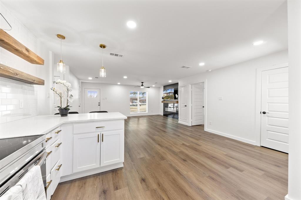 3227 Mayhew Drive Dallas, TX 75228 - Photo 12 of 25 a large kitchen with a lot of counter space and wooden floor