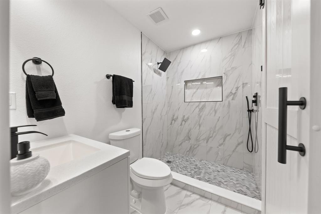 3227 Mayhew Drive Dallas, TX 75228 - Photo 16 of 25 a bathroom with a sink a toilet and shower