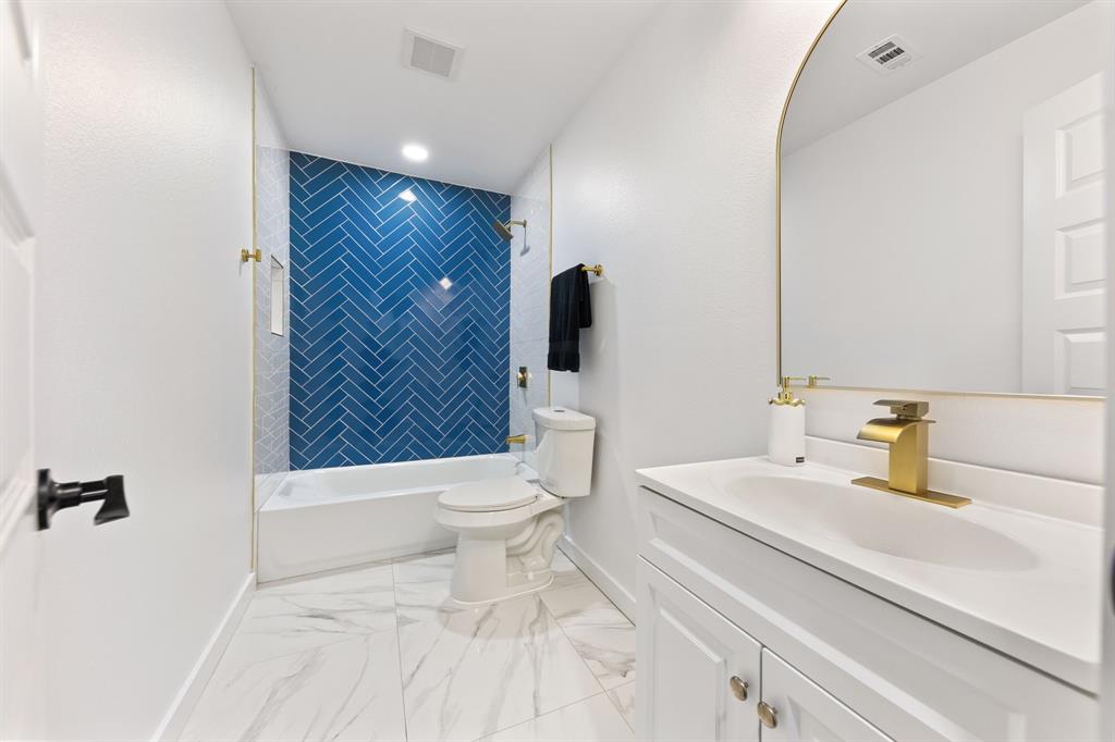 3227 Mayhew Drive Dallas, TX 75228 - Photo 21 of 25 a bathroom with a sink a toilet and shower