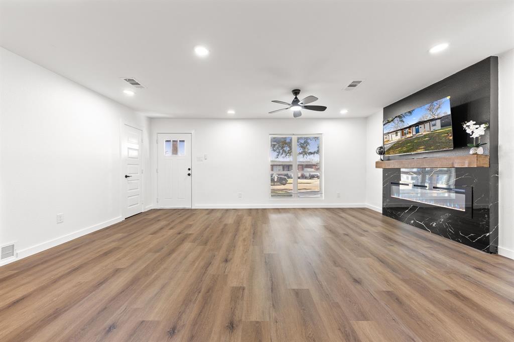 3227 Mayhew Drive Dallas, TX 75228 - Photo 7 of 25 wooden floor in an empty room with a window