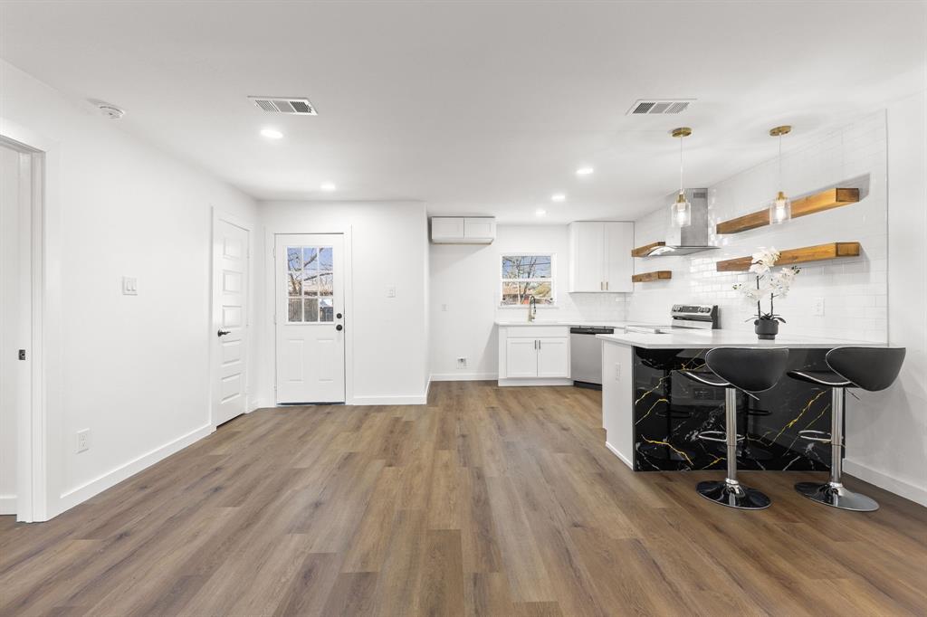 3227 Mayhew Drive Dallas, TX 75228 - Photo 8 of 25 a living room with stainless steel appliances kitchen island hardwood floor and a sink