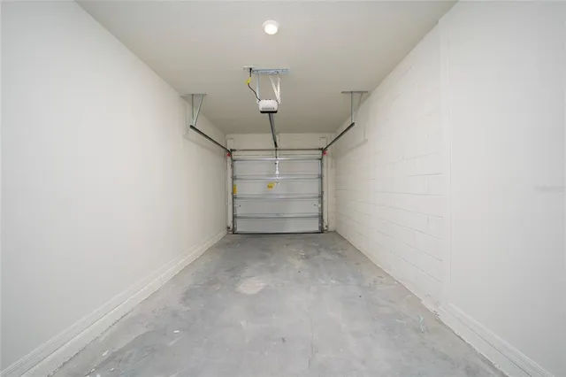 an empty room with a ceiling fan and window