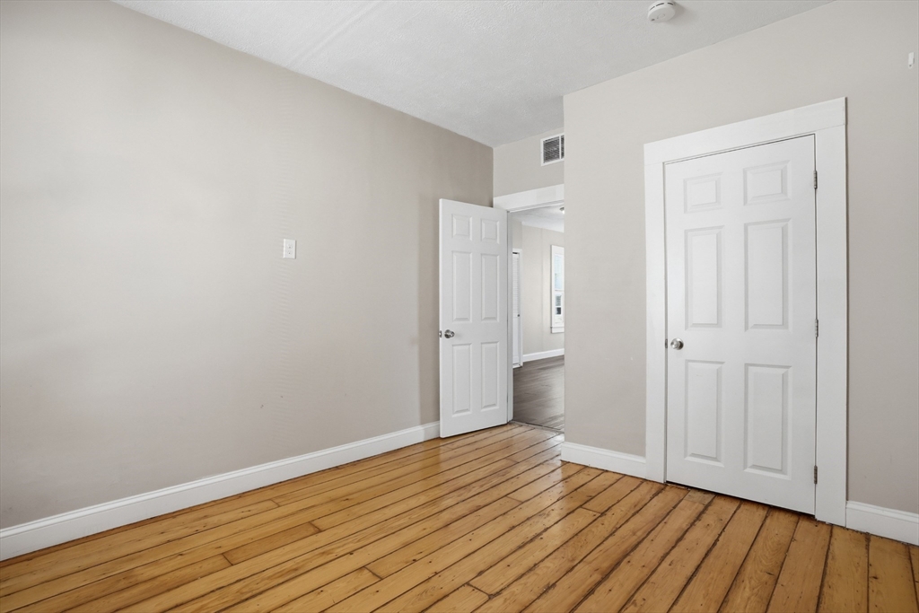 196 Irving Street Fall River, MA 02723 - Photo 17 of 34 a view of an empty room with wooden floor