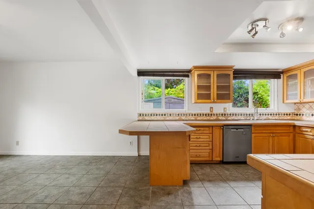a view of a kitchen with kitchen island wooden floor and a window