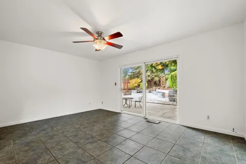 en empty room with windows and entrance