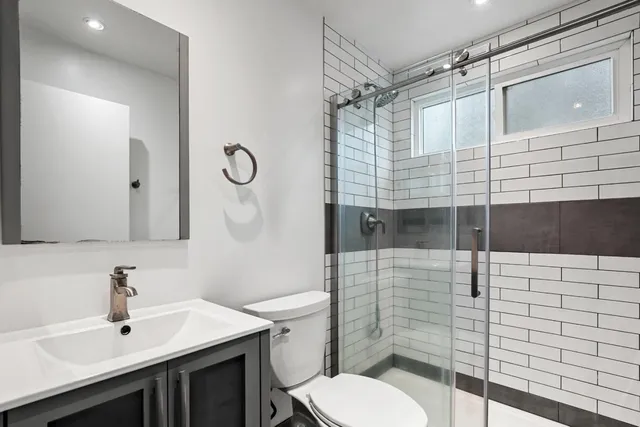 a bathroom with a sink toilet and shower