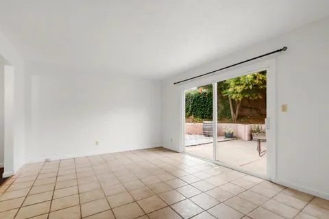 a view of an empty room with glass door
