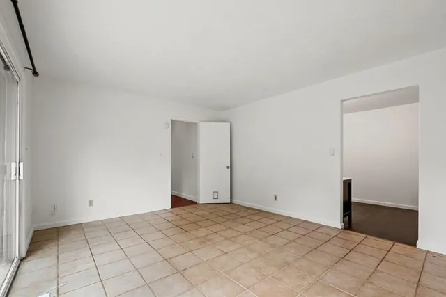 a spacious bedroom with a bed and a dresser