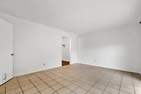 a spacious bedroom with a bed and a dresser