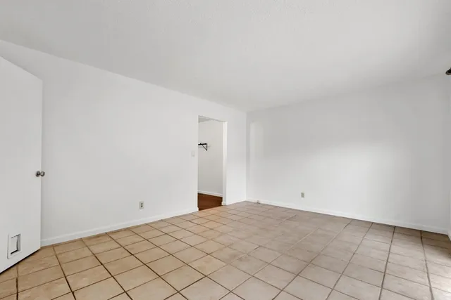 a spacious bedroom with a bed and a dresser