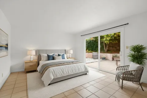 a spacious bedroom with a bed and a large window