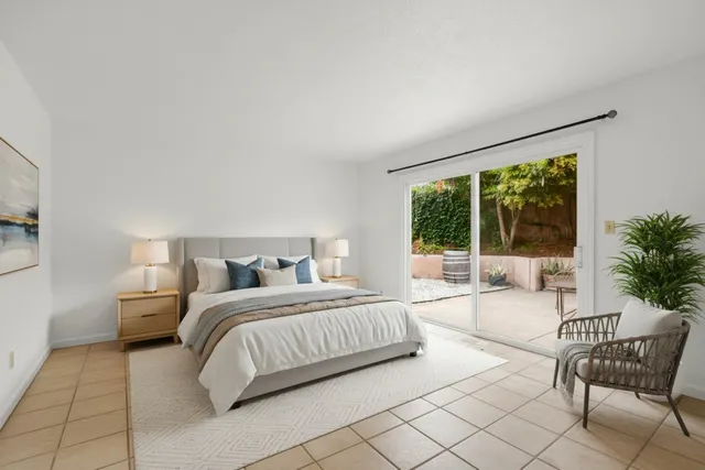 a spacious bedroom with a bed and a large window