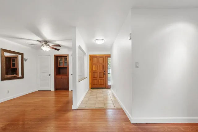 a view of hallway with wooden floor