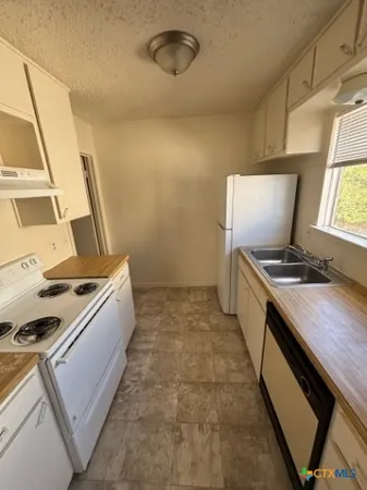 a kitchen with a stove and a window