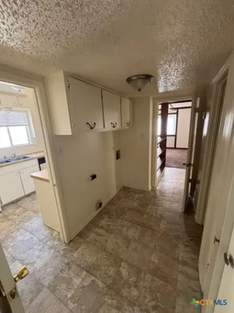 a view of a hallway view with furniture and a window