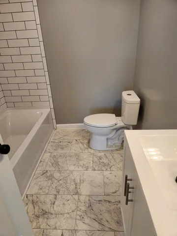 a bathroom with a toilet and bathtub