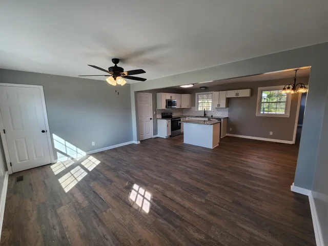 a view of a kitchen with a sink cabinets and wooden floor