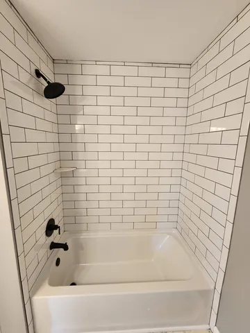 a bathroom with a bathtub and a shower