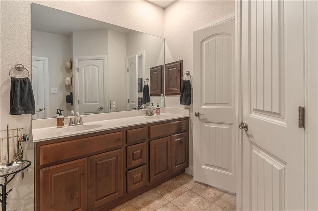 6708 Menchaca Road, Unit 14 Austin, TX 78745 - Photo 4 of 22 Double vanity with dual sinks and coordinating chrome fixtures
