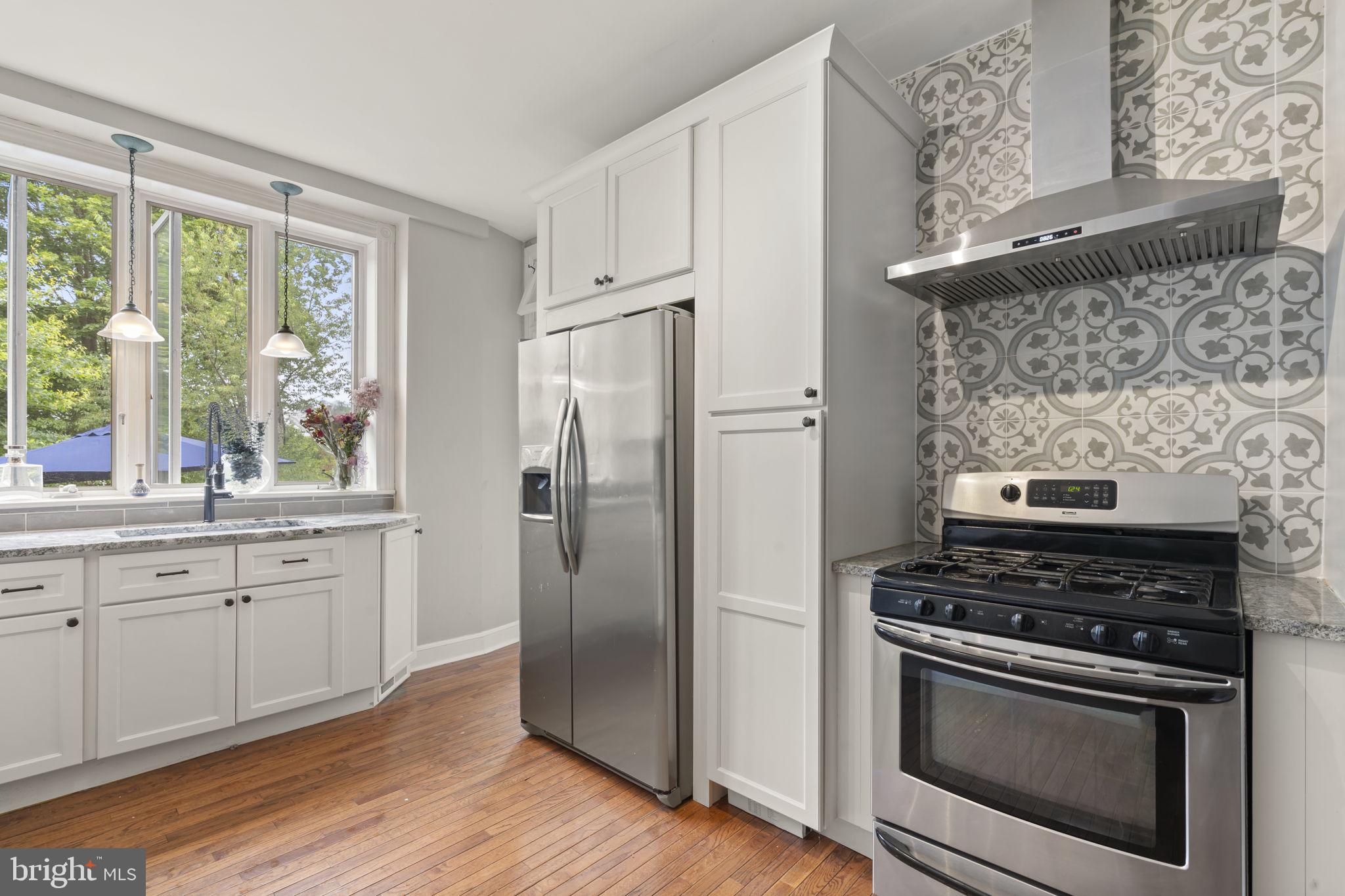 33 Waverly Road Wyncote, PA 19095 - Photo 11 of 28 a kitchen with granite countertop a stove oven and sink