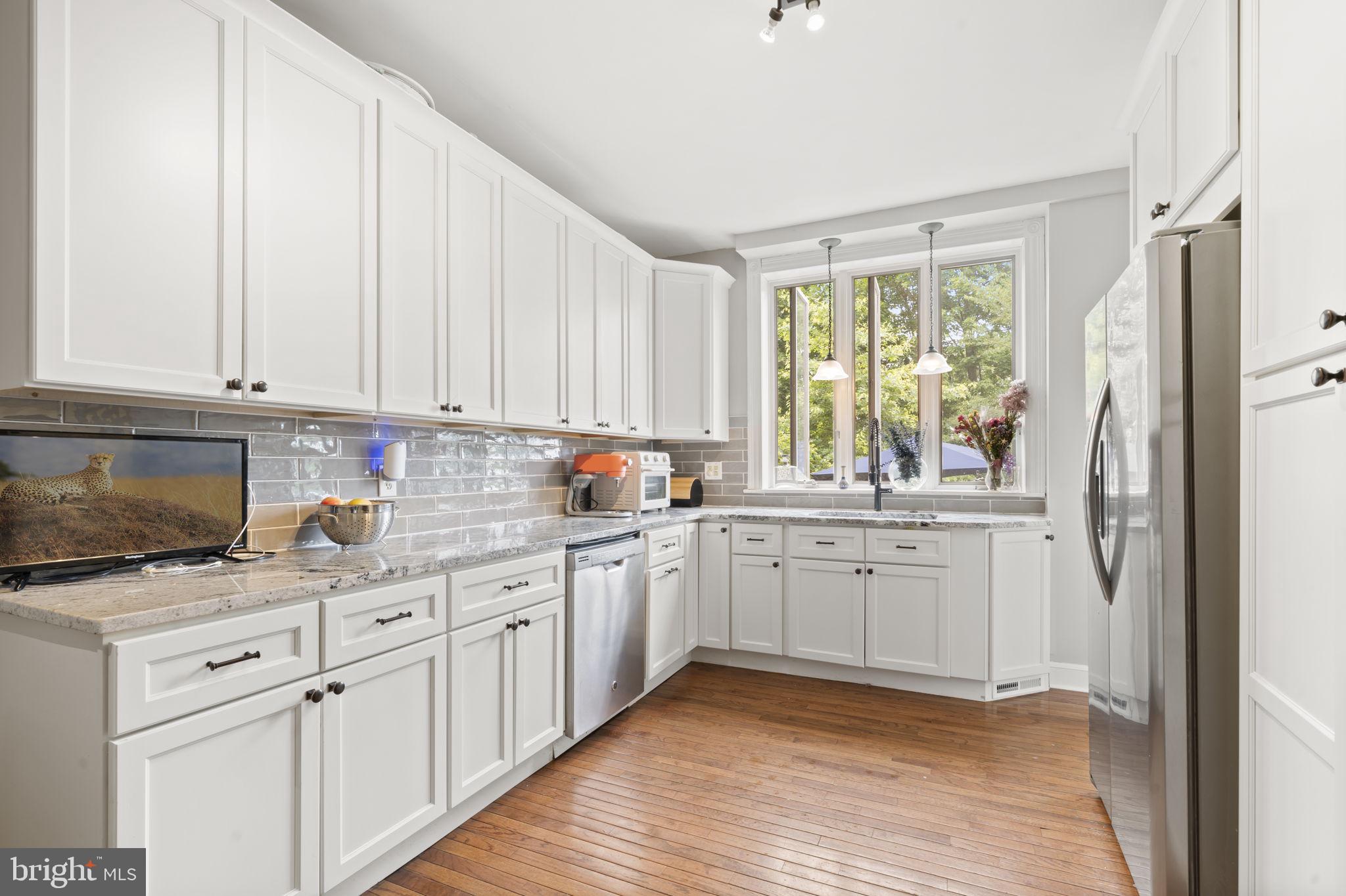 33 Waverly Road Wyncote, PA 19095 - Photo 9 of 28 a kitchen with stainless steel appliances granite countertop a stove a sink and a refrigerator