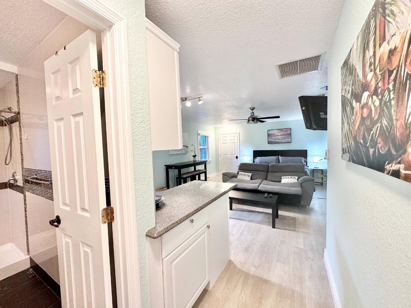 6100 Francis Street, Unit B Jupiter, FL 33458 - Photo 11 of 19 a kitchen view with stainless steel appliances a stove a sink and a refrigerator