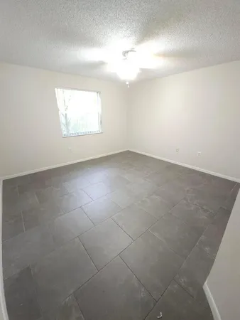 an empty room with a empty space and windows