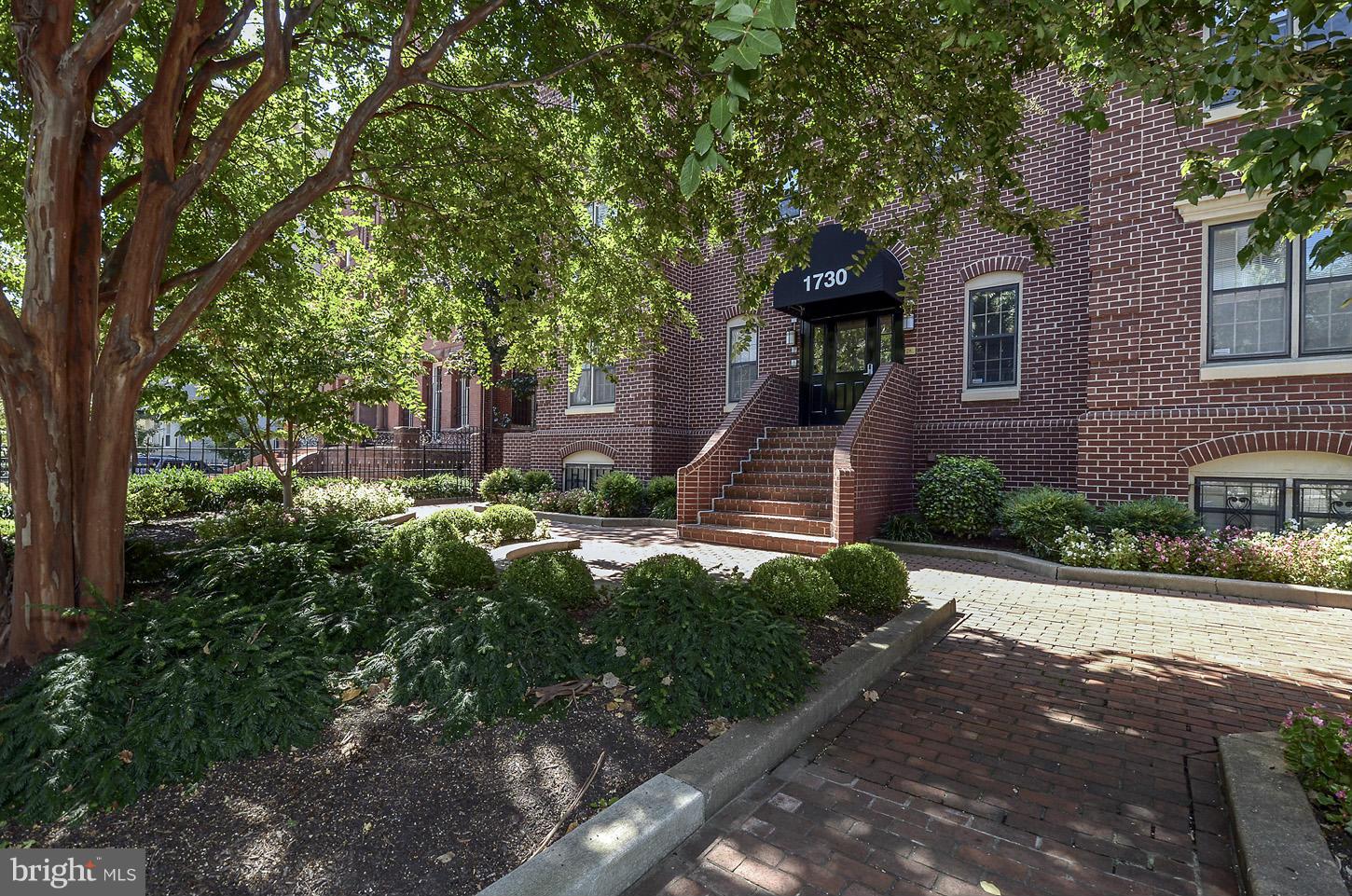 1730 16th Street Northwest, Unit 14 Washington, DC 20009 - Photo 1 of 17 a front view of a house with a yard