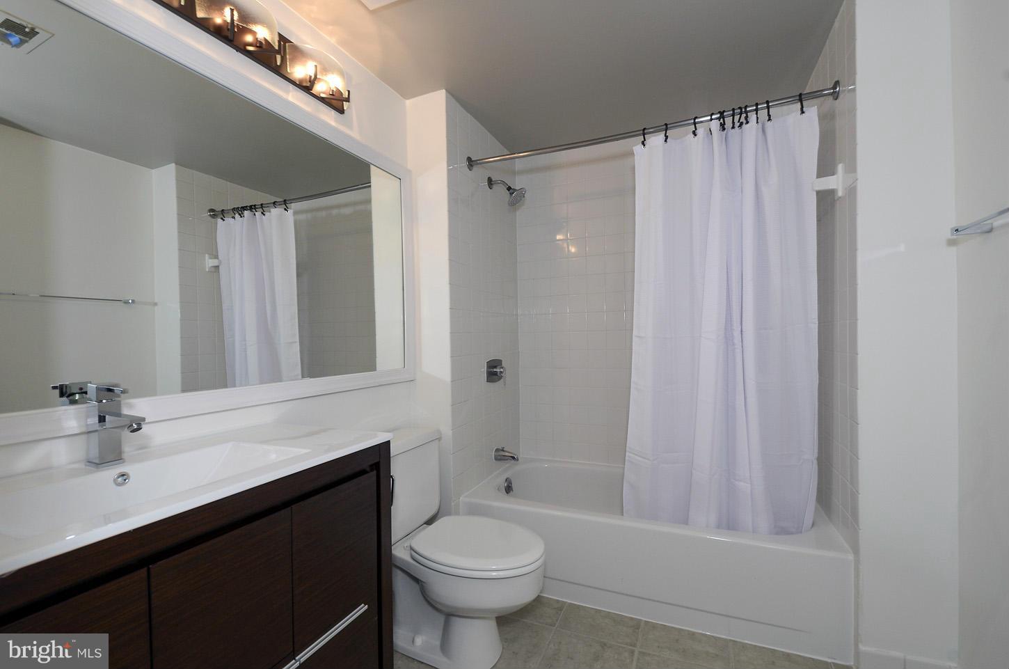 1730 16th Street Northwest, Unit 14 Washington, DC 20009 - Photo 14 of 17 a bathroom with a sink a toilet and shower