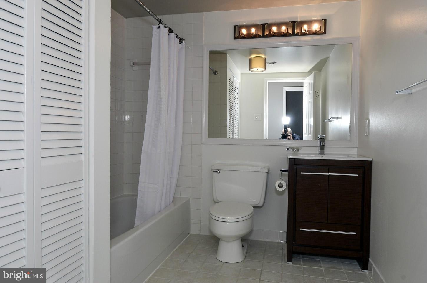 1730 16th Street Northwest, Unit 14 Washington, DC 20009 - Photo 16 of 17 a bathroom with a toilet sink and mirror