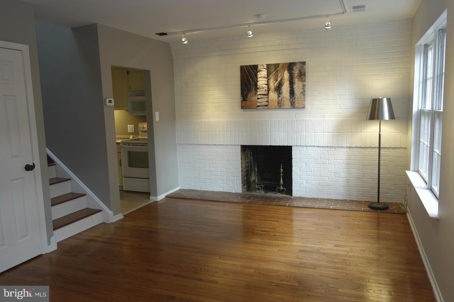 1730 16th Street Northwest, Unit 14 Washington, DC 20009 - Photo 4 of 17 an empty room with wooden floor and a fireplace
