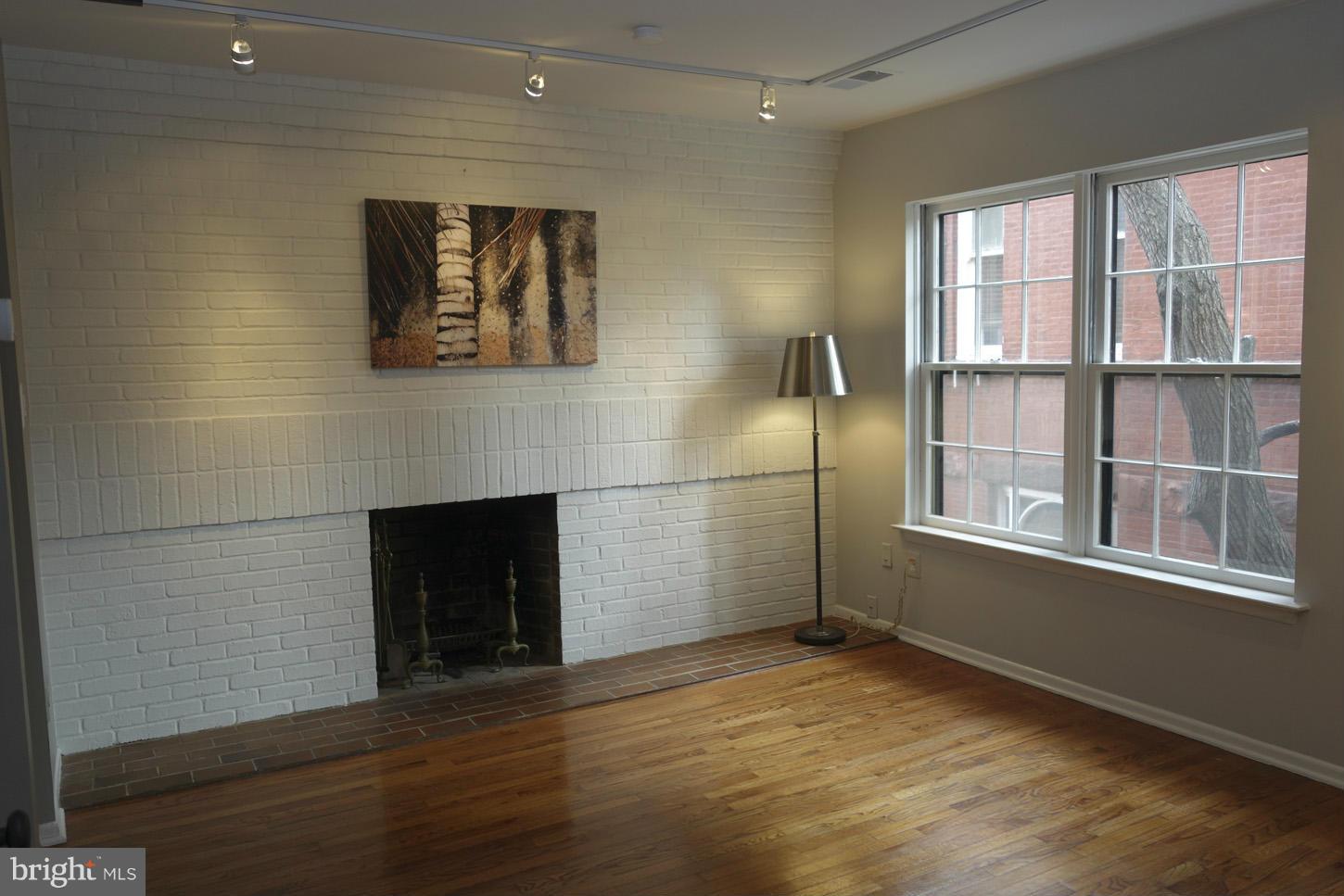 1730 16th Street Northwest, Unit 14 Washington, DC 20009 - Photo 5 of 17 a view of empty room with a fireplace and wooden floor