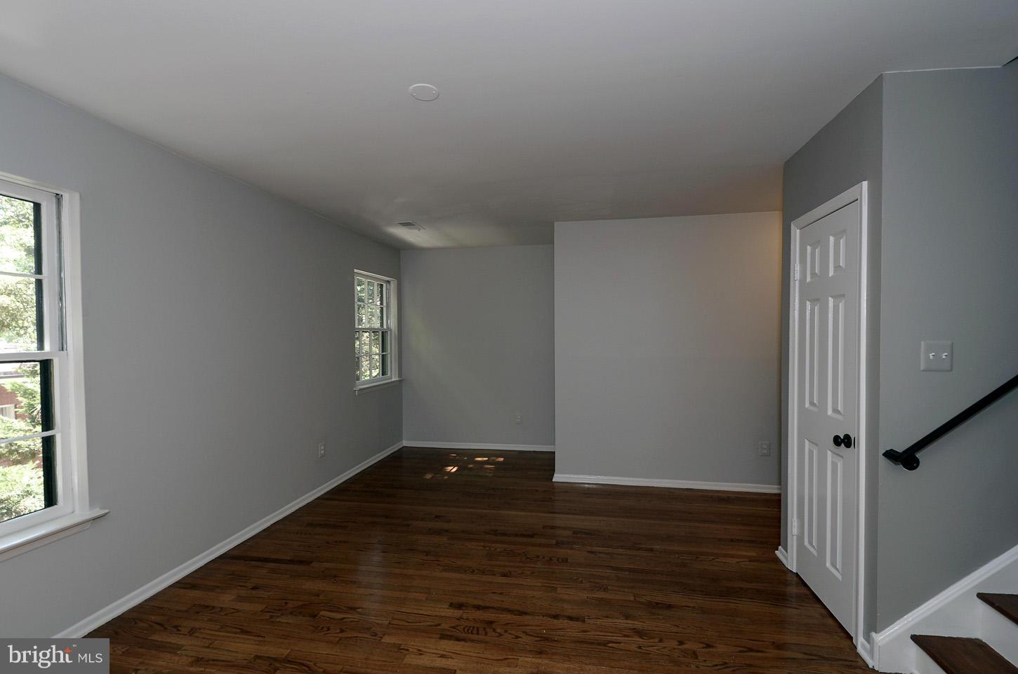1730 16th Street Northwest, Unit 14 Washington, DC 20009 - Photo 7 of 17 a view of an empty room with wooden floor and a window