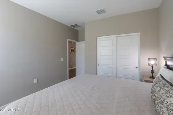 a bedroom with a bed and a lamp