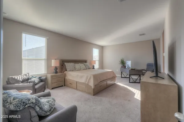 a bedroom with a bed couch and window