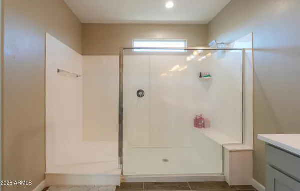 a bathroom with a shower and a sink