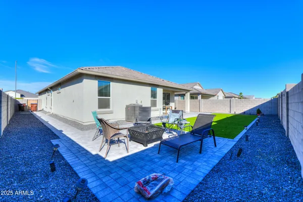 a view of a house with backyard and sitting area