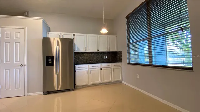 a kitchen with stainless steel appliances a refrigerator and a stove top oven