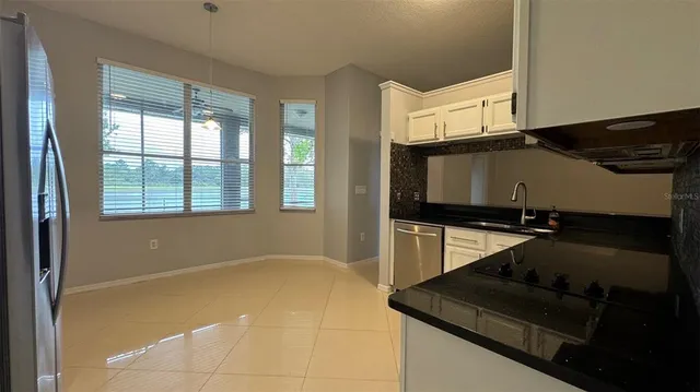 a kitchen with a sink a microwave a stove and a refrigerator