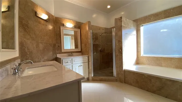 a bathroom with a sink tub shower and a mirror