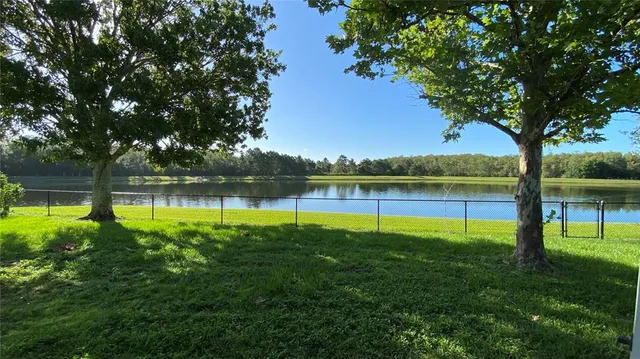a view of a lake with houses in the background