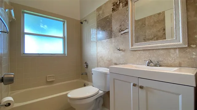 a bathroom with a sink toilet vanity and shower