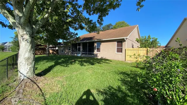 a view of backyard of house with green space