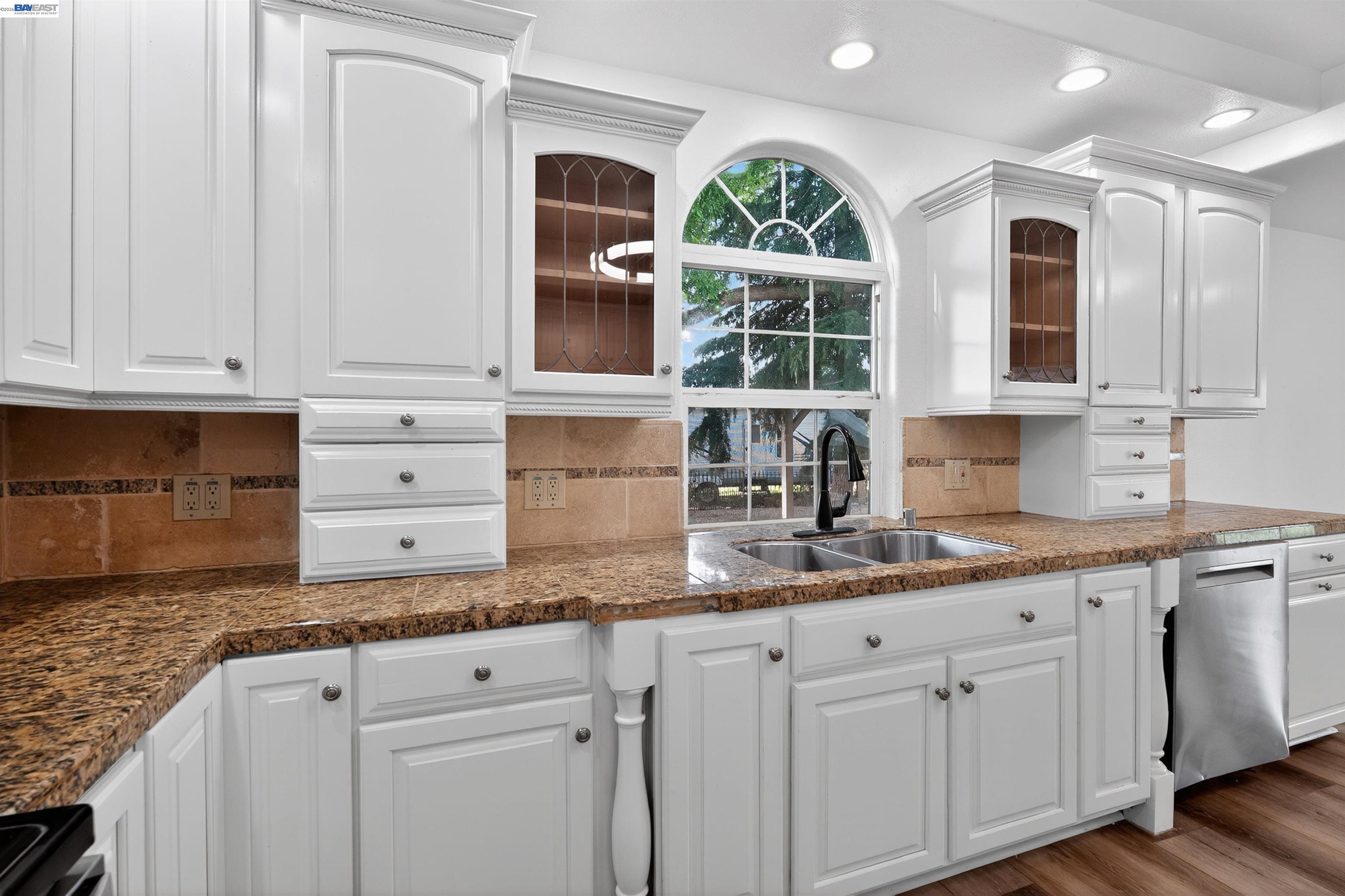 3015 Point Pleasant Road Elk Grove, CA 95757 - Photo 10 of 32 a kitchen with granite countertop white cabinets and window