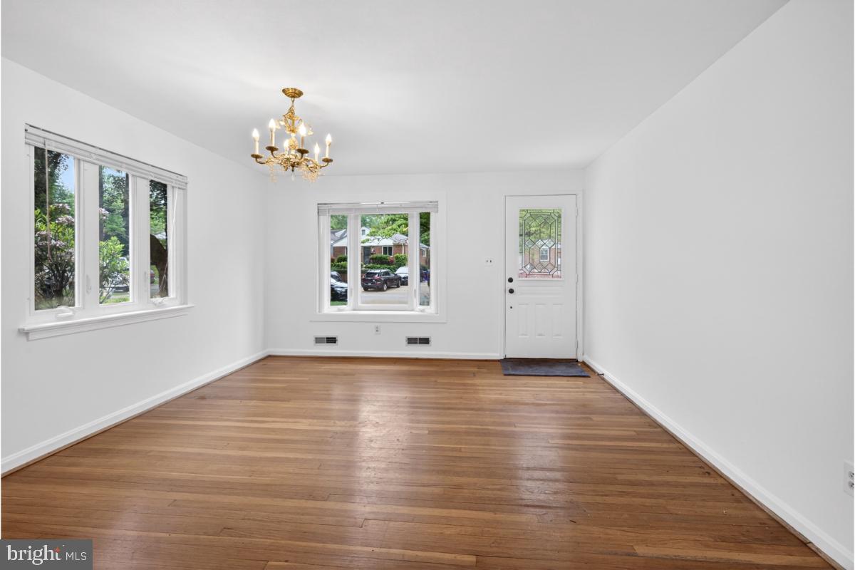 4068 Adams Drive Silver Spring, MD 20902 - Photo 8 of 43 a view of an empty room with a window and wooden floor