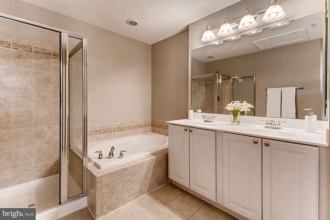 5136 Key View Way Perry Hall, MD 21128 - Photo 21 of 28 a bathroom with a bathtub a double vanity sink and a mirror