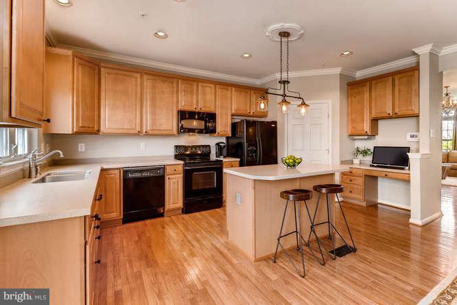 5136 Key View Way Perry Hall, MD 21128 - Photo 8 of 28 a kitchen with stainless steel appliances a stove top oven a sink dishwasher and a refrigerator with wooden floor
